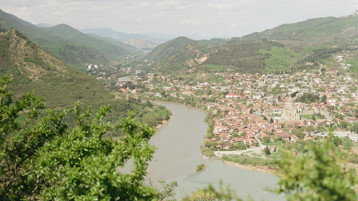 A scenic valley town with a river